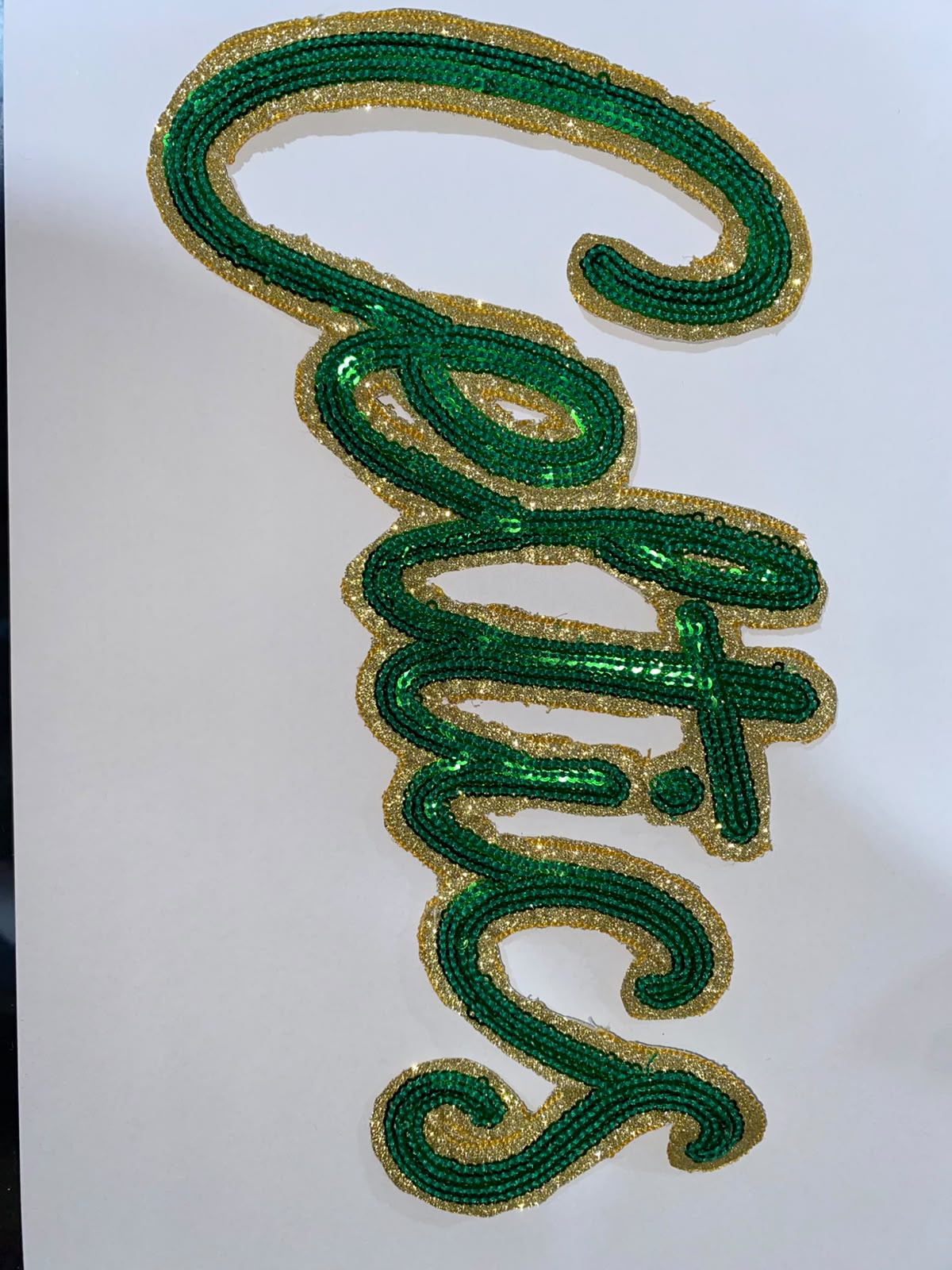 Green and gold sequin script embroidery motif for a ladies dress